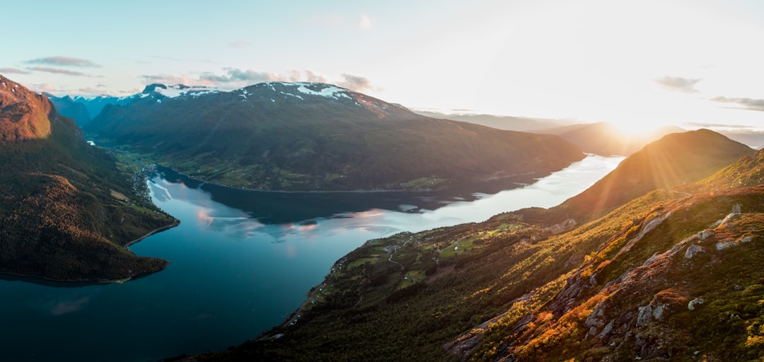 Majestic Norwegian fjords at golden hour with mountain reflections
